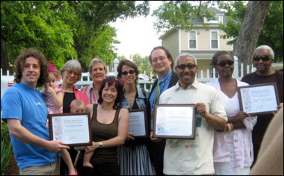 Participating homeowners display their recognition awards